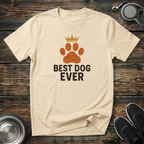 Cream unisex t-shirt with distressed burnt-orange crowned paw print graphic and bold "Best Dog Ever" block lettering — funny dog parent gift tee for dog moms and dads