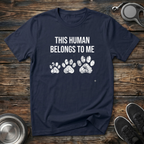 This Human Belongs To Me Funny Dog Owner T-Shirt – Bold Paw Print Graphic Tee Told From the Dog's Perspective