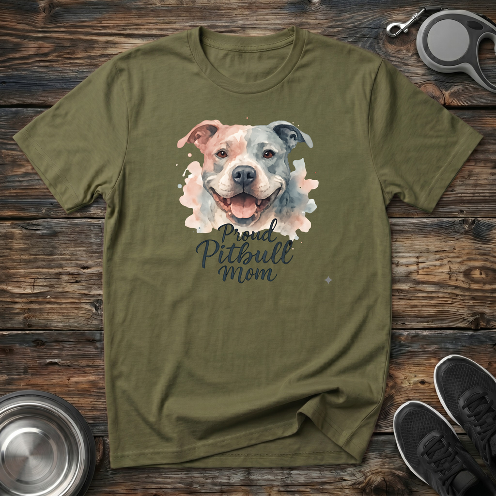 Military green unisex t-shirt with soft watercolor Pitbull portrait in blush pink and grey tones and elegant "Proud Pitbull Mom" dark script lettering — beautiful bully breed lover gift tee