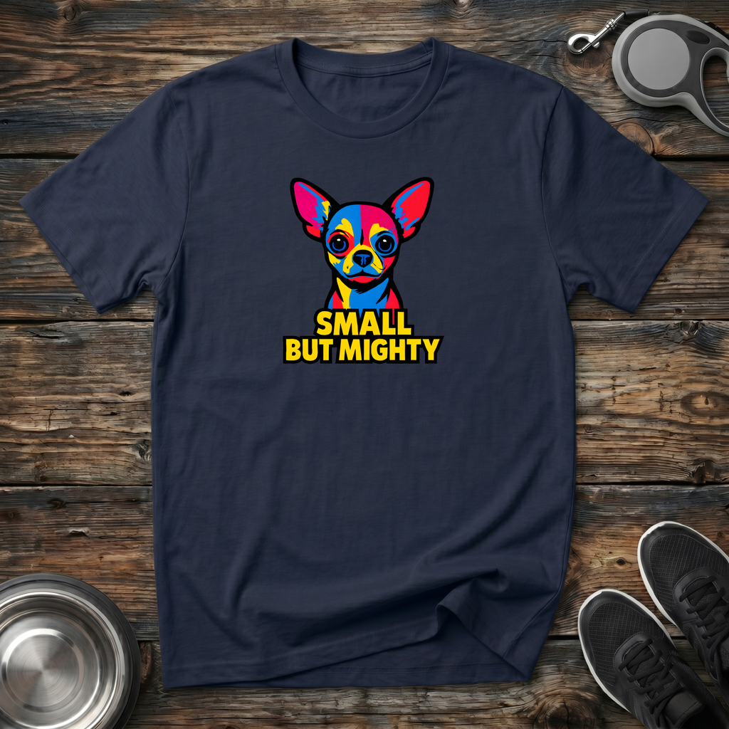 Navy blue unisex t-shirt with vivid pop art Chihuahua portrait in bold primary colors and bright yellow "Small But Mighty" block lettering — funny Chihuahua lover gift tee for small dog moms and dads