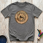 Caffeine and Cats charcoal t-shirt with stunning vintage wood
burn badge of cat in steaming coffee cup surrounded by coffee
beans in warm sepia gold tones, artisan cat coffee lover tee