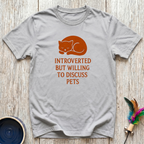 Introverted But Willing to Discuss Pets charcoal t-shirt with
bold burnt orange sleepy curled cat design, funny pet lover
introvert tee and universal animal lover gift