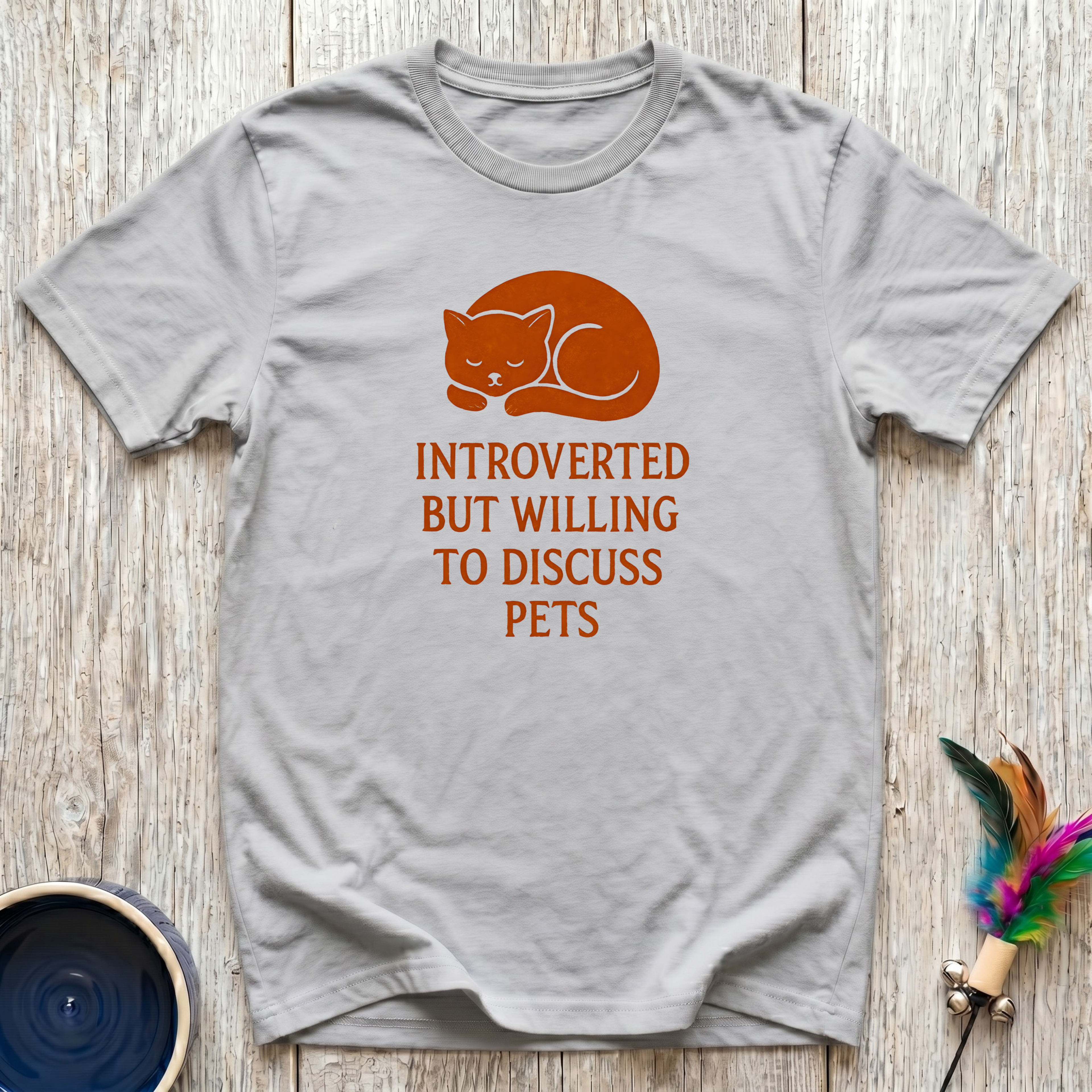 Introverted But Willing to Discuss Pets charcoal t-shirt with
bold burnt orange sleepy curled cat design, funny pet lover
introvert tee and universal animal lover gift