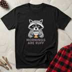 Mornings Are Ruff black t-shirt with bold full colour grumpy
raccoon clutching coffee cup, funny pet coffee lover tee
and dog mom morning gift