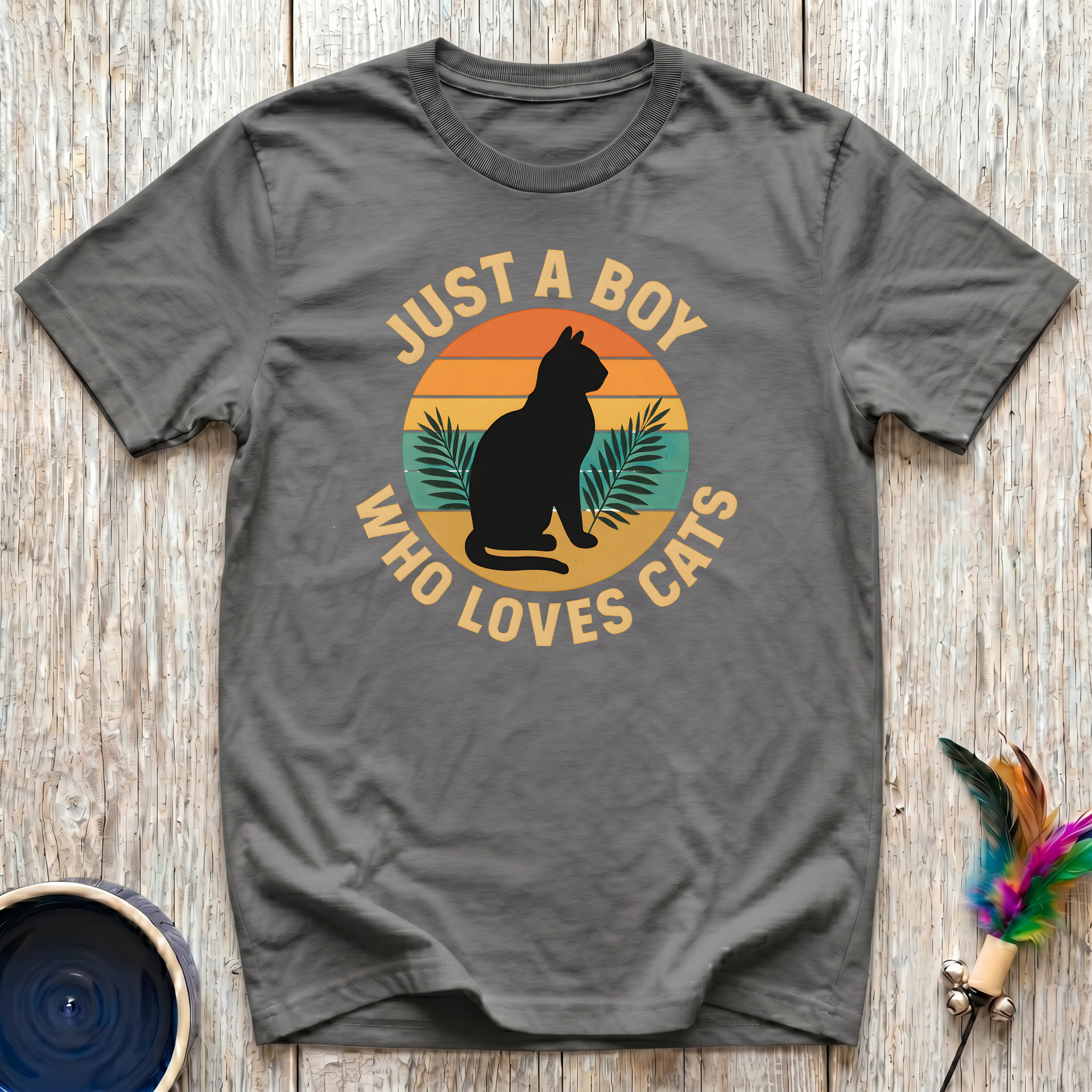 Just a Boy Who Loves Cats charcoal t-shirt with bold retro
tropical sunset circle cat silhouette and palm fronds in orange
rust teal and gold, funny cat dad tee and men cat lover gift