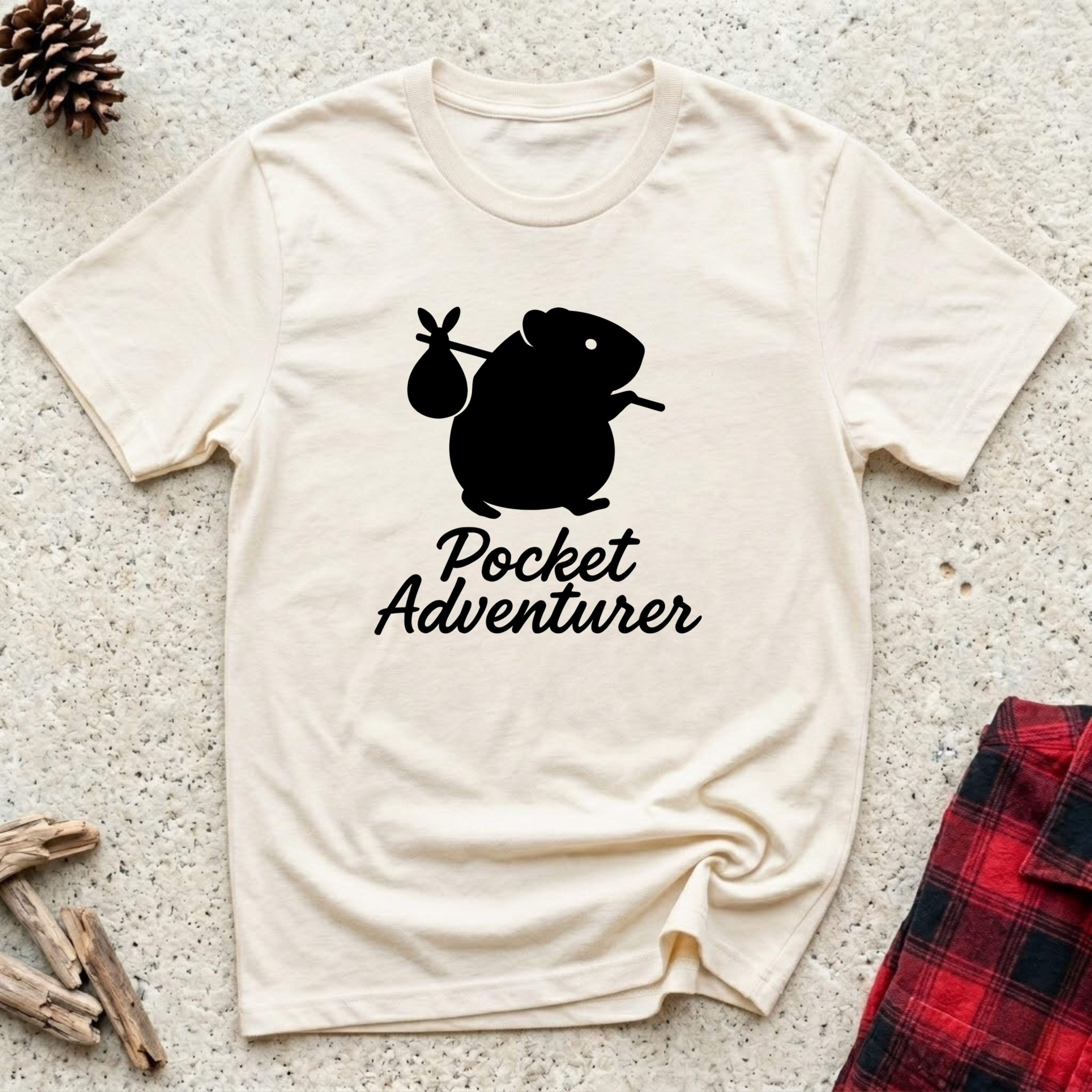 Pocket Adventurer cream t-shirt with bold black guinea pig
silhouette carrying a bindle, funny guinea pig lover tee and cavy owner gift